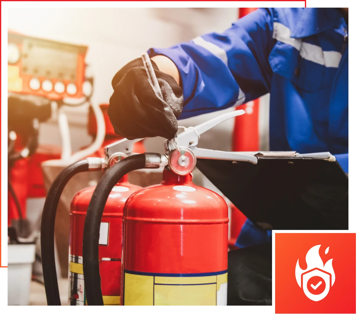 Worker inspecting red fire extinguishers